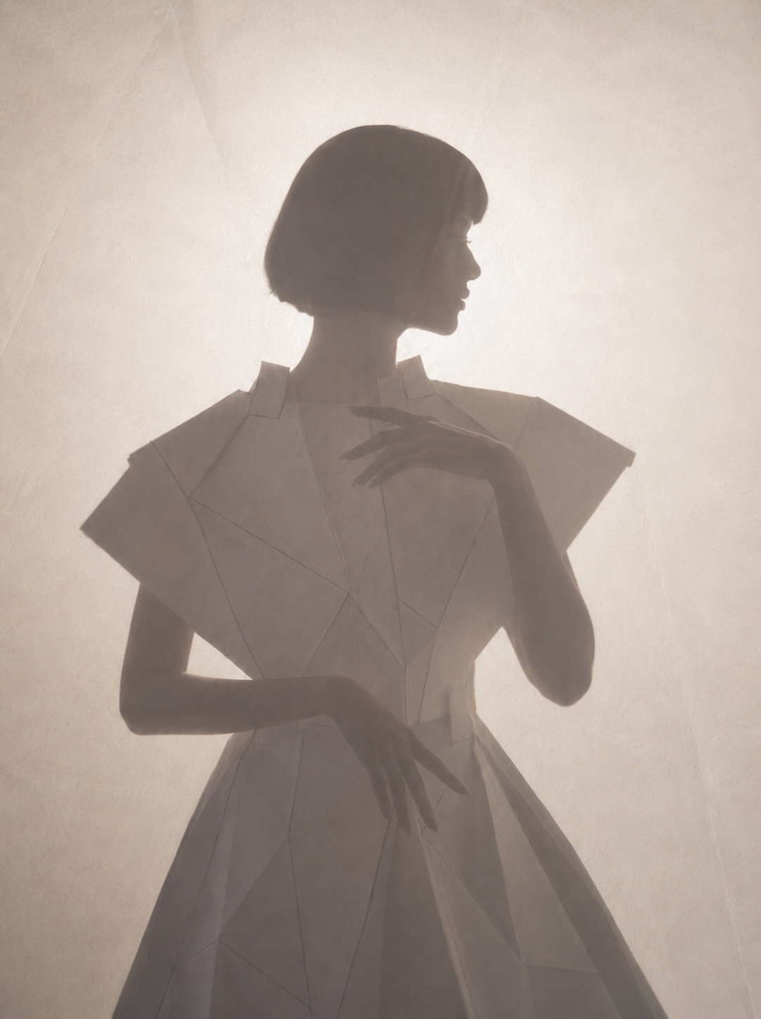 Silhouette féminine en robe blanche sculptée – atmosphère brumeuse et lumière diffuse