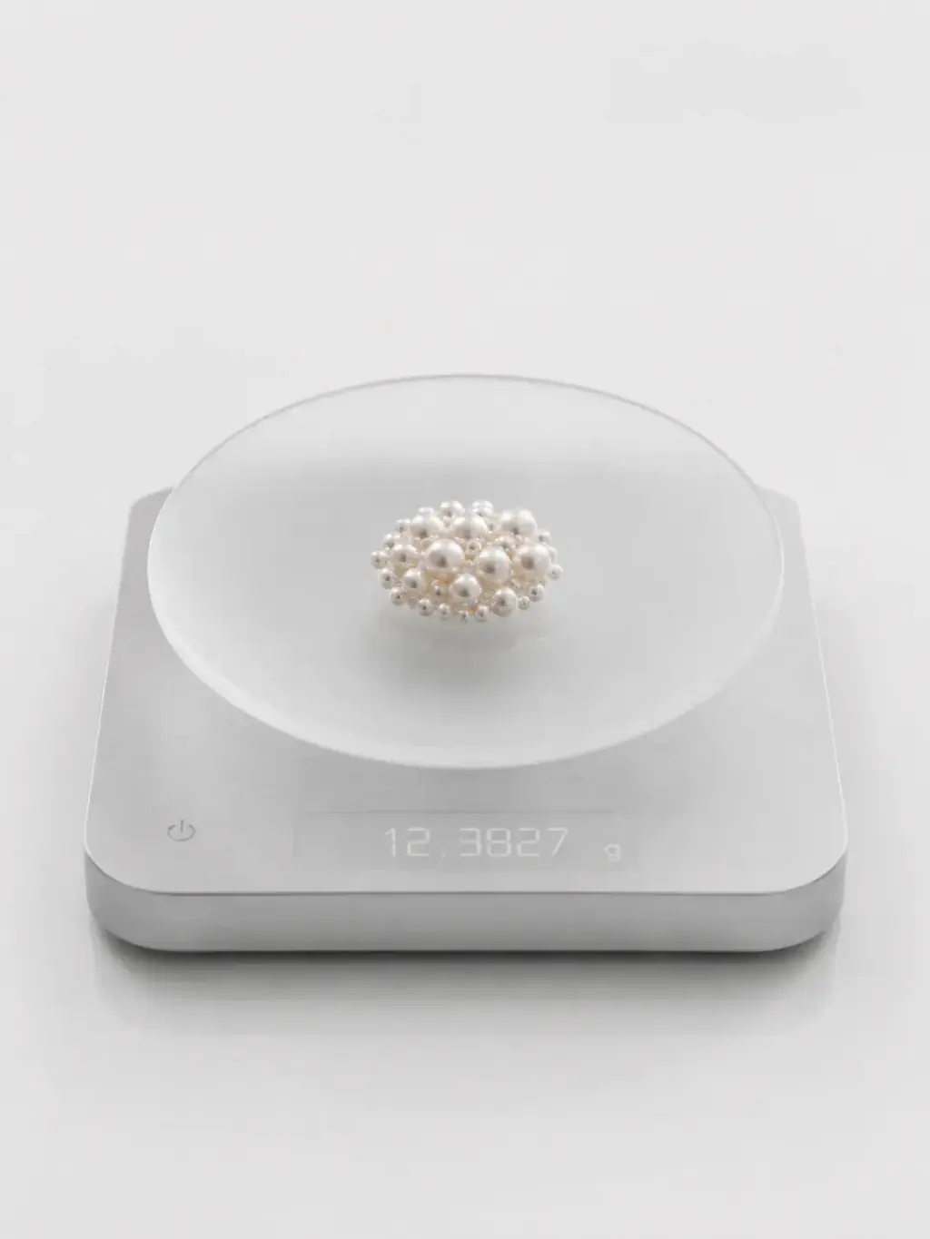 Amas de perles de culture sur balance de précision digitale, pesée nacrée entre science et luxe