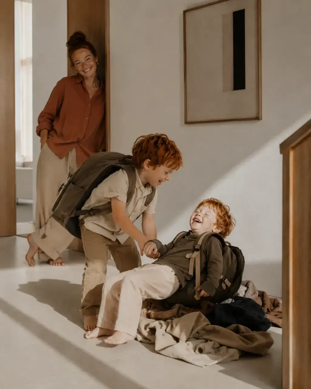 Mère souriante regardant ses fils s'amuser dans le couloir